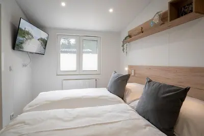 Ein Bett oder Betten in einem Zimmer der Unterkunft Ostseecamp Ferienhaus 