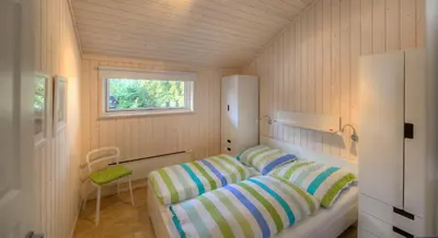 Ein Bett oder Betten in einem Zimmer der Unterkunft Timmenhus - Ferienhäuser am Feldrand