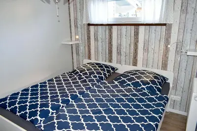 Ein Bett oder Betten in einem Zimmer der Unterkunft Lütt Hus an de See Ferienwohnung