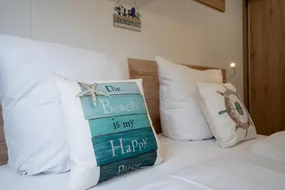 Ein Bett oder Betten in einem Zimmer der Unterkunft Ostseecamp Ferienhaus 