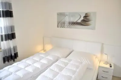 Ein Bett oder Betten in einem Zimmer der Unterkunft Strandhotel Ferienwohnung Nr 10