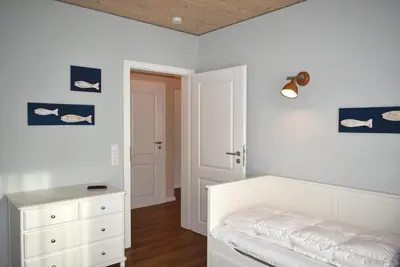 Ein Bett oder Betten in einem Zimmer der Unterkunft Villa Somersby Ferienwohnung Nr 03