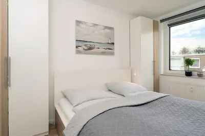 Ein Bett oder Betten in einem Zimmer der Unterkunft Höppnerweg 5 Seemöwe 18