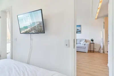 Ein Bett oder Betten in einem Zimmer der Unterkunft Höppnerweg 5 Seemöwe 18