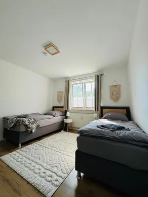 Ein Bett oder Betten in einem Zimmer der Unterkunft Familientraum an der wunderschönen Ostsee in Scharbeutz - Strandnah, kostenloses Parken & Terasse!W2