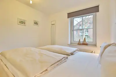 Ein Bett oder Betten in einem Zimmer der Unterkunft Haus Windrose Appartement 2