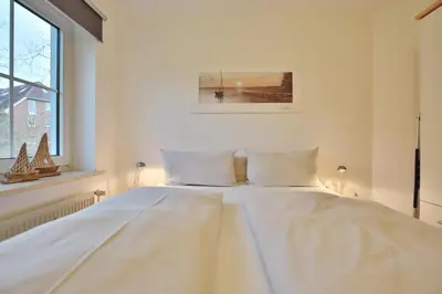 Ein Bett oder Betten in einem Zimmer der Unterkunft Haus Windrose Appartement 2