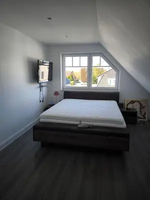 Ein Bett oder Betten in einem Zimmer der Unterkunft Familienzeit, moderne Ferienwohnung mit Sauna in Timmendorfer Strand