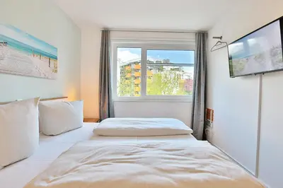 Ein Bett oder Betten in einem Zimmer der Unterkunft Strandglück Haus C Strandglück Appartement 10C