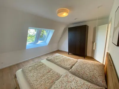 Ein Bett oder Betten in einem Zimmer der Unterkunft Timmenhus - neue Ferienwohnungen im historischen Bauernhaus