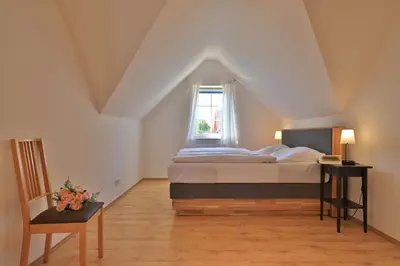 Ein Bett oder Betten in einem Zimmer der Unterkunft Wellenreiter Ferienhaus