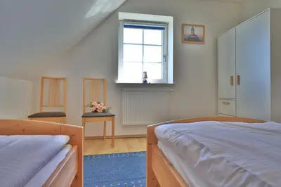 Ein Bett oder Betten in einem Zimmer der Unterkunft Wellenreiter Ferienhaus