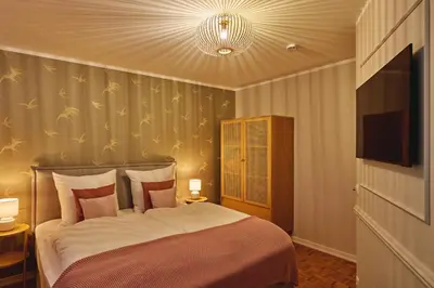 Ein Bett oder Betten in einem Zimmer der Unterkunft Lykke Hus - Wohnung Mathildas Garten EG