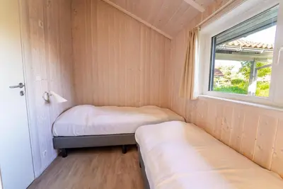 Ein Bett oder Betten in einem Zimmer der Unterkunft Strandblick - Dorf 1 Ferienhaus 20
