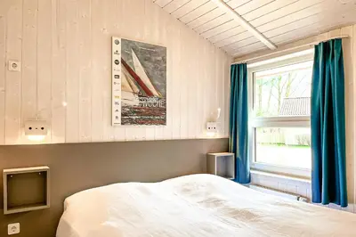 Ein Bett oder Betten in einem Zimmer der Unterkunft Strandblick - Dorf 1 Ferienhaus 01