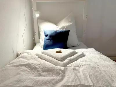 Ein Bett oder Betten in einem Zimmer der Unterkunft Moderne Ambient Apartments direkt in der Lübecker Altstadt