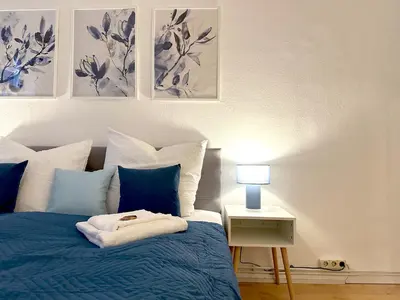 Ein Bett oder Betten in einem Zimmer der Unterkunft Moderne Ambient Apartments direkt in der Lübecker Altstadt