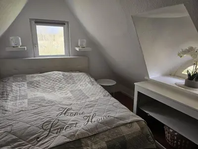 Ein Bett oder Betten in einem Zimmer der Unterkunft Reetdachhaus am See
