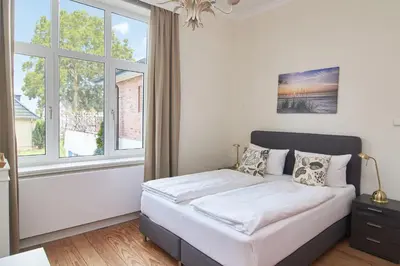 Ein Bett oder Betten in einem Zimmer der Unterkunft Villa Dünenblick Doppelzimmer Bernstein