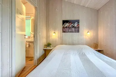 Ein Bett oder Betten in einem Zimmer der Unterkunft Pulverhorn - Dorf 4 Ferienhaus 01