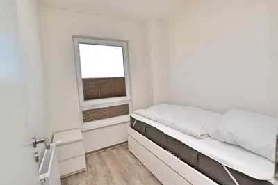 Ein Bett oder Betten in einem Zimmer der Unterkunft Appartementhaus Zur Sonne - Whg. F