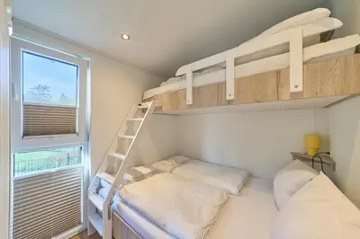 Ein Bett oder Betten in einem Zimmer der Unterkunft Ostseecamp Ferienhaus 