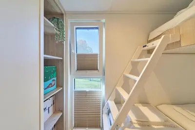 Ein Etagenbett oder Etagenbetten in einem Zimmer der Unterkunft Ostseecamp Ferienhaus 