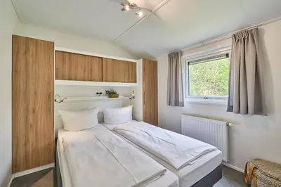 Ein Bett oder Betten in einem Zimmer der Unterkunft Süsel Seeparx Ferienhaus Se e hnsucht