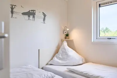 Ein Bett oder Betten in einem Zimmer der Unterkunft Süsel Seeparx Ferienhaus Sonneninsel