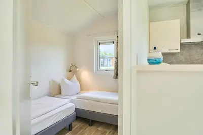 Ein Bett oder Betten in einem Zimmer der Unterkunft Süsel Seeparx Ferienhaus Iona