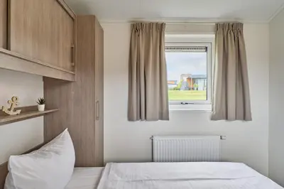 Ein Bett oder Betten in einem Zimmer der Unterkunft Süsel Seeparx Ferienhaus Seehafen