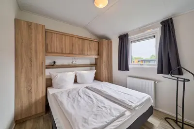 Ein Bett oder Betten in einem Zimmer der Unterkunft Süsel Seeparx Ferienhaus Ankerplatz