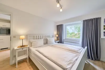 Ein Bett oder Betten in einem Zimmer der Unterkunft Süsel Seeparx Ferienwohnung Seeblick