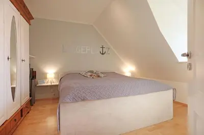 Ein Bett oder Betten in einem Zimmer der Unterkunft Barendorf Padua Ferienwohnung