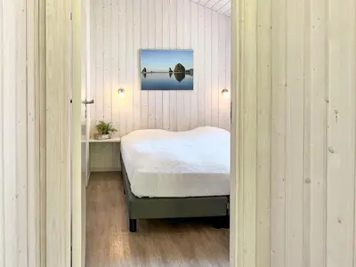 Ein Bett oder Betten in einem Zimmer der Unterkunft Schatzkiste - Dorf Ferienhaus 08