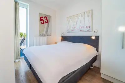 Ein Bett oder Betten in einem Zimmer der Unterkunft Promenadenvilla 03 Wohnung 10