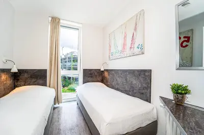 Ein Bett oder Betten in einem Zimmer der Unterkunft Promenadenvilla 03 Wohnung 04