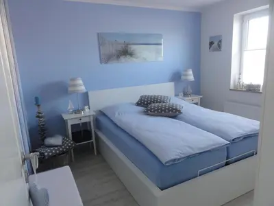 Ein Bett oder Betten in einem Zimmer der Unterkunft Strandschlösschen Utkiek
