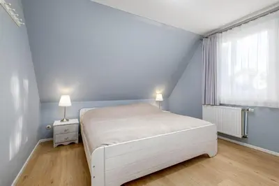 Ein Bett oder Betten in einem Zimmer der Unterkunft Haus Schmökel, App Leuchtturm