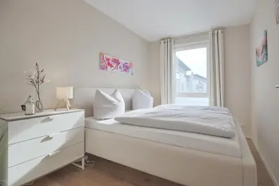Ein Bett oder Betten in einem Zimmer der Unterkunft Strandglück Haus A Strandglück Appartrement 17A
