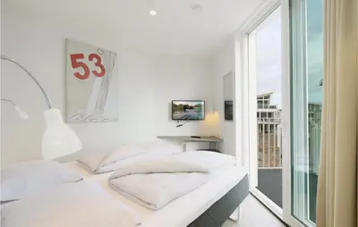 Ein Bett oder Betten in einem Zimmer der Unterkunft Dünenvilla 1, Whg 1