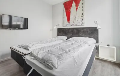 Ein Bett oder Betten in einem Zimmer der Unterkunft Dünenvilla 2, Whg 1
