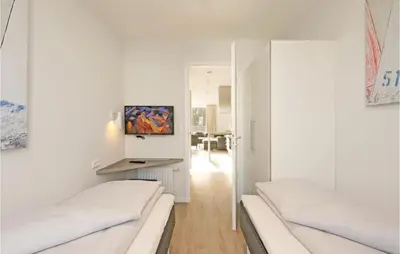 Ein Bett oder Betten in einem Zimmer der Unterkunft Dünenvilla 8, Whg 1