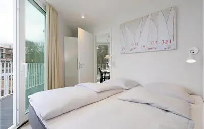 Ein Bett oder Betten in einem Zimmer der Unterkunft Dünenvilla 9, Whg 1