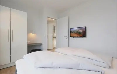 Ein Bett oder Betten in einem Zimmer der Unterkunft Dünenvilla 9, Whg 1
