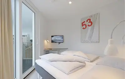 Ein Bett oder Betten in einem Zimmer der Unterkunft Dünenvilla 9, Whg 4