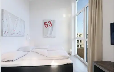 Ein Bett oder Betten in einem Zimmer der Unterkunft Dünenvilla 10, Whg 5