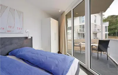 Ein Bett oder Betten in einem Zimmer der Unterkunft Dünenvilla 17, Whg 2