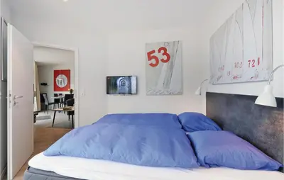 Ein Bett oder Betten in einem Zimmer der Unterkunft Dünenvilla 17, Whg 2