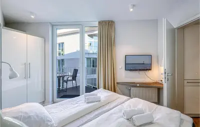Ein Bett oder Betten in einem Zimmer der Unterkunft Dünenvilla 17, Whg 3